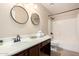 Well-lit bathroom features double vanity, framed mirrors, and a shower-tub combination at 2977 E Teakwood Pl, Chandler, AZ 85249