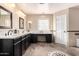 Luxurious primary bathroom boasts double sinks, sleek cabinetry, and a decorative tile floor pattern at 2977 E Teakwood Pl, Chandler, AZ 85249