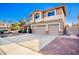 Two-story home featuring a three-car garage and low-maintenance desert landscaping at 2977 E Teakwood Pl, Chandler, AZ 85249