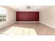 Spacious living room with tile floors, large window, ceiling fan, and a contrasting accent wall at 2977 E Teakwood Pl, Chandler, AZ 85249