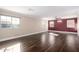 Expansive living room is enhanced with gleaming hardwood floors, neutral walls, and sun-filled windows at 2977 E Teakwood Pl, Chandler, AZ 85249