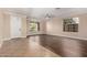 Open-concept living room with hardwood floors, large windows, and a neutral color palette at 2977 E Teakwood Pl, Chandler, AZ 85249