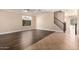 Bright living room with hardwood floors, a ceiling fan, and a staircase to the upper level at 2977 E Teakwood Pl, Chandler, AZ 85249