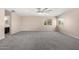 Expansive main bedroom featuring a ceiling fan, neutral carpet, and bright windows overlooking the yard at 2977 E Teakwood Pl, Chandler, AZ 85249