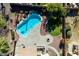 Aerial view of a backyard featuring a kidney-shaped pool, a grassy area, desert landscaping and a built-in BBQ at 2977 E Teakwood Pl, Chandler, AZ 85249