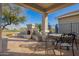 Charming covered back patio with outdoor fireplace and cozy seating area at 30153 N Gecko Trl, San Tan Valley, AZ 85143