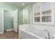 Bright bathroom showcasing a soaking tub, glass shower, neutral tile and pleasant paint color at 30153 N Gecko Trl, San Tan Valley, AZ 85143