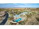 Aerial view of the community pool, clubhouse, and golf course showcasing community amenities at 30153 N Gecko Trl, San Tan Valley, AZ 85143