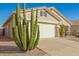 Close up of the front of the home showing desert landscaping and a two-car garage at 30153 N Gecko Trl, San Tan Valley, AZ 85143