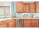 A bright kitchen featuring wood cabinets, stainless steel appliances, a dishwasher, and light countertops at 30153 N Gecko Trl, San Tan Valley, AZ 85143