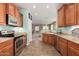 A kitchen featuring stainless steel appliances, wood cabinets, tile flooring, and natural lighting at 30153 N Gecko Trl, San Tan Valley, AZ 85143