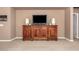 Cozy living room with wood cabinet against taupe walls, and neutral carpet at 30153 N Gecko Trl, San Tan Valley, AZ 85143