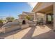 Covered outdoor patio featuring an outdoor fireplace and dining area, perfect for entertaining guests at 30153 N Gecko Trl, San Tan Valley, AZ 85143