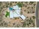 Bird's-eye view of a desert home with a private pool, artificial turf area, and a circular driveway at 30600 N Pima Rd # 24, Scottsdale, AZ 85266