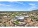 Breathtaking aerial view of a luxurious desert home with pool, landscaping, and panoramic desert views at 30600 N Pima Rd # 24, Scottsdale, AZ 85266