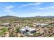 Expansive aerial view of a luxury desert home with pool, landscaping, and stunning mountain views at 30600 N Pima Rd # 24, Scottsdale, AZ 85266