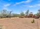 Backyard features a basketball hoop and a large outdoor oven surrounded by desert plants and hardscape at 30600 N Pima Rd # 24, Scottsdale, AZ 85266