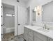 Bright bathroom featuring a double vanity with marble counters and gray cabinets at 30600 N Pima Rd # 24, Scottsdale, AZ 85266