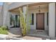 Inviting front entrance with a wood door, desert landscaping, and a hanging lantern under the porch at 30600 N Pima Rd # 24, Scottsdale, AZ 85266