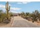 Stunning desert home with a long driveway, natural landscaping, and spacious three-car garage at 30600 N Pima Rd # 24, Scottsdale, AZ 85266