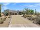 Stunning Southwestern home with a spacious driveway and three-car garage, surrounded by desert landscaping at 30600 N Pima Rd # 24, Scottsdale, AZ 85266