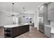Spacious open concept kitchen with stainless appliances and a dark wood kitchen island with marble countertop at 30600 N Pima Rd # 24, Scottsdale, AZ 85266