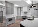 Updated kitchen with modern gray cabinets, stainless steel appliances, marble counters, and pendant lighting at 30600 N Pima Rd # 24, Scottsdale, AZ 85266