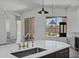 Kitchen island with sink and modern faucet offering views of the backyard pool and outdoor patio at 30600 N Pima Rd # 24, Scottsdale, AZ 85266