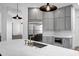 Contemporary kitchen boasts an island with marble countertop, brass faucet, and stainless steel appliances at 30600 N Pima Rd # 24, Scottsdale, AZ 85266
