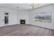 Cozy living room featuring fireplace, hardwood floors, recessed lights, and pool views at 30600 N Pima Rd # 24, Scottsdale, AZ 85266