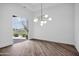 Bright living room with sleek hardwood floors, modern lighting, and a large sliding glass door offering outdoor access at 30600 N Pima Rd # 24, Scottsdale, AZ 85266