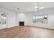 Living room showcasing a fireplace, large window with backyard views, and contemporary light fixture at 30600 N Pima Rd # 24, Scottsdale, AZ 85266