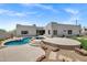 Gorgeous backyard oasis with pool, spa, desert landscaping, and views of the luxurious home's exterior at 30600 N Pima Rd # 24, Scottsdale, AZ 85266