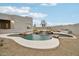 Beautiful outdoor pool with a waterfall feature, surrounded by desert landscaping and an attached spa at 30600 N Pima Rd # 24, Scottsdale, AZ 85266