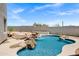 Inviting backyard pool with rock waterfall, desert landscaping, and a charming desert oasis at 30600 N Pima Rd # 24, Scottsdale, AZ 85266