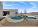 Stunning backyard pool features a rock waterfall, desert landscaping, and an inviting patio with desert views at 30600 N Pima Rd # 24, Scottsdale, AZ 85266