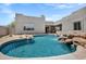 Beautiful backyard pool with desert landscaping and a rock waterfall feature in a luxury desert home at 30600 N Pima Rd # 24, Scottsdale, AZ 85266