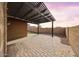 Backyard patio with pergola showing pavers, small grass section and block wall at 34705 N 26Th Ave, Phoenix, AZ 85086