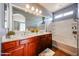 Bathroom featuring double sinks, vanity, framed mirrors, and a shower-tub combo at 34705 N 26Th Ave, Phoenix, AZ 85086