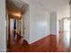 Long hallway with hardwood floors and neutral paint, leading to other rooms at 34705 N 26Th Ave, Phoenix, AZ 85086