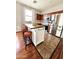 A kitchen island with seating, dark wood top, storage, and bar stools is featured at 34705 N 26Th Ave, Phoenix, AZ 85086