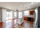 Open-concept kitchen featuring cherry cabinets, island with seating, stainless steel appliances and wood floors at 34705 N 26Th Ave, Phoenix, AZ 85086