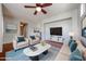 Bright living room featuring a ceiling fan, hardwood floors, and a decorative rug and furniture at 34705 N 26Th Ave, Phoenix, AZ 85086