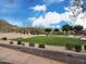 Scenic community park featuring lush green spaces, playground, and a volleyball court in a picturesque setting at 34705 N 26Th Ave, Phoenix, AZ 85086