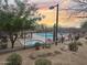 Community pool with desert landscaping, shaded seating, and decorative perimeter fence at 34705 N 26Th Ave, Phoenix, AZ 85086