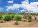 Community tennis courts with covered seating, desert landscape, and perimeter fence at 34705 N 26Th Ave, Phoenix, AZ 85086