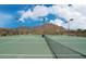 Community tennis courts with mountain views, net, and perimeter fence at 34705 N 26Th Ave, Phoenix, AZ 85086