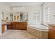 Bathroom featuring dual vanities, granite countertops, and a corner soaking tub at 37654 N 102Nd Pl, Scottsdale, AZ 85262