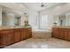 Bright bathroom with dual vanity sinks, a soaking tub, and marble floors at 37654 N 102Nd Pl, Scottsdale, AZ 85262