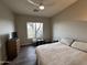 Cozy bedroom featuring a queen-size bed, dresser, and view of the desert landscape at 37654 N 102Nd Pl, Scottsdale, AZ 85262